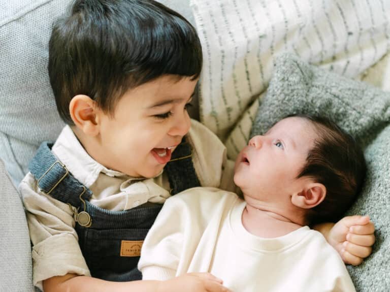 Nicos big brother holding him during a newborn session at home in Hamilton