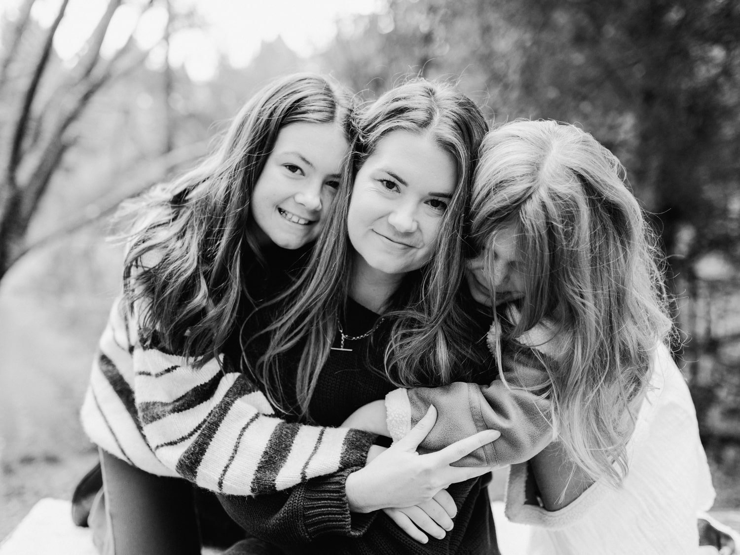 Katie getting a face smoosh by her two daughters during a family session at McLaren Falls Park