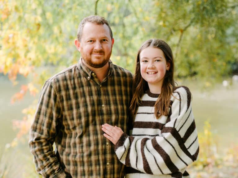 Ben and Addi standing beside each other during a family session at McLaren Falls Park